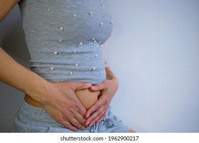 Hands On Bally Indicating Health Problems Such As Appendicitis, Abdominal Pain, Gut Problems, Women's Health Problems, Pregnancy Or Immune Problems. Background Is White, In The Picture Is Woman.