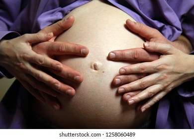 Hands on the belly of a pregnant woman, Kyiv, Ukraine 
