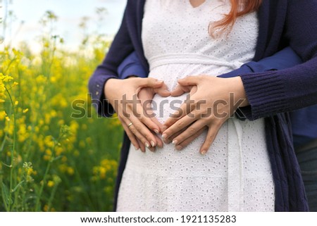 Foto Bild Schwanger machendes Herz mit Händen auf nacktem Bauch mit Partnerin