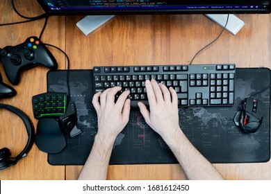 Hands On A Black Keyboard. Around A Gaming Keyboard, A Game Pad Mouse. Top View
