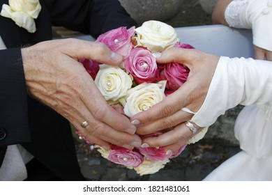 Hands On A Bridal Bouqet