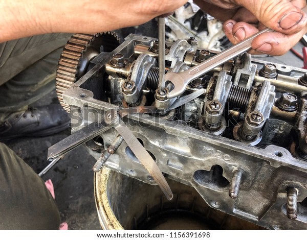 Hands on Car Engine\
Block petrol gasoline cylinder cam shaft spring rocker arm valve\
Repair refurbish 