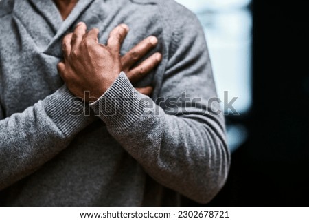 Hands on chest, heart attack and sick black man with medical emergency on mockup. Pain, cardiology and senior male person with cardiac arrest, heartburn or stroke, breathing problem and health risk.