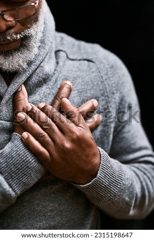 Hands on chest, heart attack and senior black man with medical emergency in studio isolated on a background. Pain, cardiology and African male person with cardiac arrest, heartburn or stroke problem.