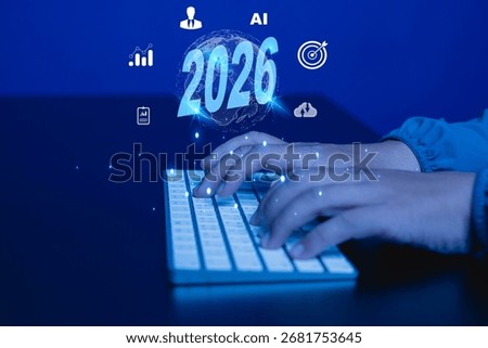 Hands on computer keyboard with AI and 2026 glowing text surrounded by technology icons representing future innovation, digital transformation, big data, and machine learning.