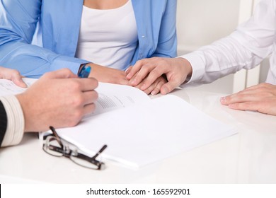 Hands on desk in a business meeting - sign a contract