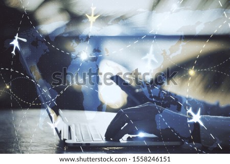 hands on desktop using laptop with airplane flight plan