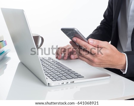 hands on a laptop keyboard and Smartphone isolated screen