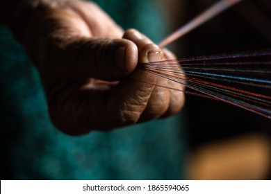 hands on a loom with thread - Shutterstock ID 1865594065