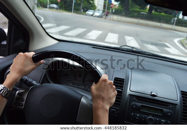 hands on the\
steering wheel in the street\
car