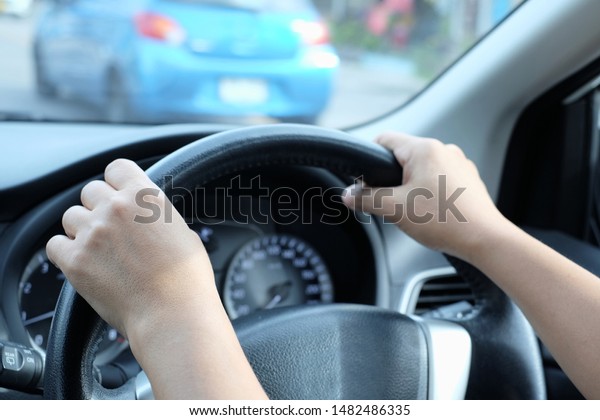 Hands on\
the steering wheel while driving on the\
road