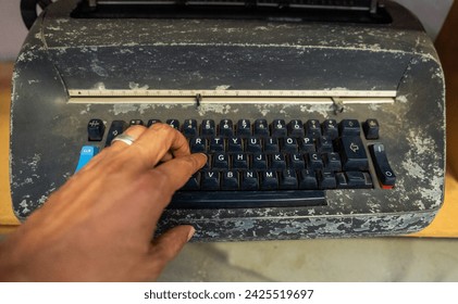 hands on typing machine typewriter old and very used.