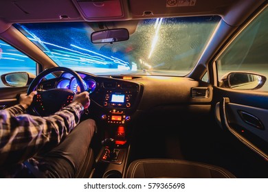 Hands On The Wheel A Car Moves At Fast Speed At The Whinter Night. Blured Road With Lights With Car On High Speed