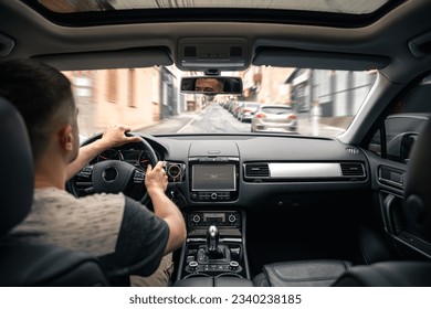 Hands on the wheel when driving at high speed from inside the car. - Shutterstock ID 2340238185