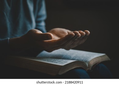 Hands Open Palm Up In Prayer On A Holy Bible In Church Concept For Faith, Spirituality, And Religion, A Woman Praying On Holy Bible In The Morning. Woman Hand With Bible Praying. Prayer Bible