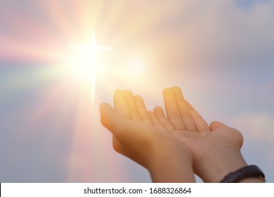 Hands Open Palm Up Worship Over Sunrise Background. Catholic Praying For Blessing From God.