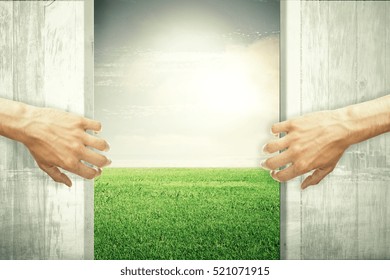 Hands Opening Abstract Wooden Doors, Revealing Green Meadow View. Nature Concept