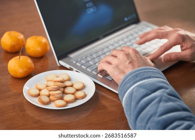Hands for operating laptops and snacks
