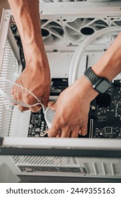 hands orchestrating the assembly of a computer fan, symbolic of the intricate symphony of components that create a functioning piece of technology
