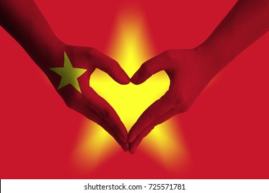 Hands painted as the VIETNAM flag forming a heart