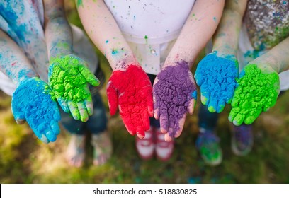 Hands / Palms of young people covered in purple, yellow, red, blue Holi festival colors isolated - Powered by Shutterstock