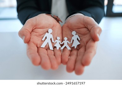 Hands, paper family and businessman with insurance for security or protection for future. Trust, safety and male agent with cutout of people for life cover, investment or asset management in office. - Powered by Shutterstock