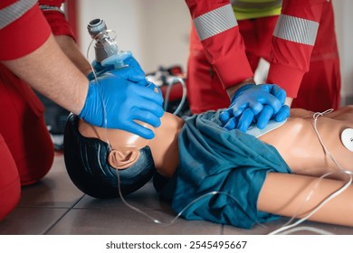 Hands of paramedic and doctor during resuscitation. Team of emergency medical service during CPR training on dummy. Themes rescue, urgency and health care. 
 - Powered by Shutterstock