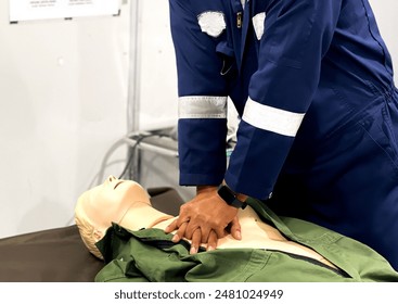 Hands of a paramedic doing chest compression during CPR and first aid training. Cardiopulmonary resuscitation class.
