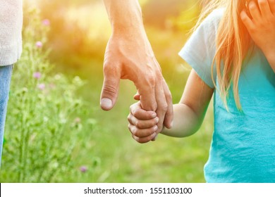 Hands Of Parent And Child In Nature