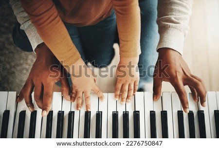 Hands, parent and kid learning piano as development of skills together and bonding while making music in a home. Closeup, musical and child playing a song on an instrument and father teaching