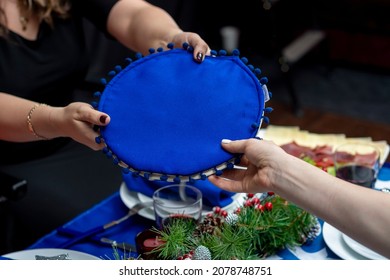 Hands Passing A Tortilla Maker At A Christmas Gathering