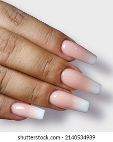 Hands with pastel pink acrylic nails manicure and paint isolated on white background