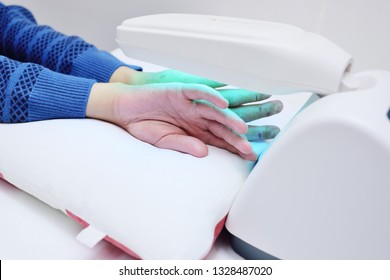 Hands Of A Patient With Psoriasis Close-up Under An Ultraviolet Lamp. Light Therapy, Phototherapy