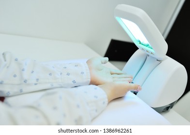 Hands Of A Patient With Psoriasis Close-up Under An Ultraviolet Lamp. Light Therapy, Phototherapy