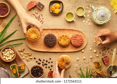 Hands Of People Eating Tasty Round Moon Cakes At Mid Autumn Festival