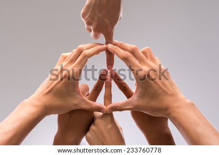 Hands of people forming a symbol of peace