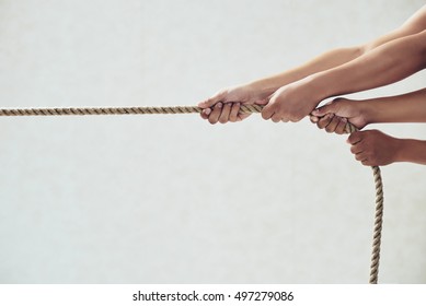 Hands Of People Pulling Tug Of War