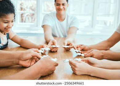 Hands, people and puzzle with collaboration at table for connect piece, jigsaw game and support of education. Family, creative and integration solution for teamwork, problem solving and house project - Powered by Shutterstock