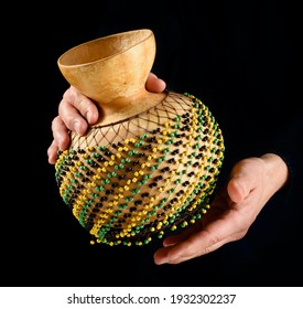 hands of percussionist playing a shekere african ethnic percussion instrument