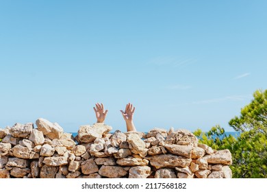 The Hands Of A Person Behind A Stone Wall - Surrender Concept