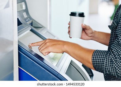 Hands Of Person With Cup Of Coffee Using Bank Terminal To Transfer Money For College