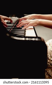 hands of a person playing the piano	