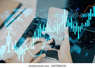 Hands of a person using phone with financial data graphs overlay, abstract charts and global map background, concept of business and technology