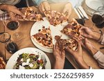 Hands, pizza and lunch as celebration in restaurant for team building or business meeting with food. Above, group of people and eating together for partnership, colleagues and collaboration in cafe