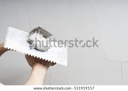 Hands Plasterer at work. Application of the plaster on the wall. textured plaster