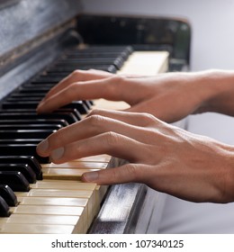 Hands Playing Old Piano
