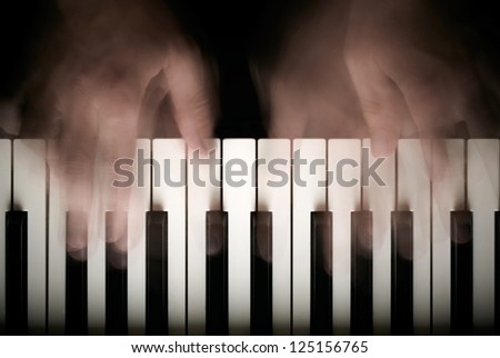 Hands playing piano. Motion blur