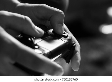 Hands playing video game with a controller