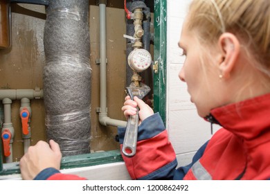 Hands Of Plumber Using Wrenches While Repairing Pipes, Close Up View. Plumber Woman Worker With Spanner Installing Water Meter