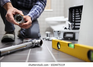 Hands Plumber At Work In A Bathroom, Plumbing Repair Service, Assemble And Install Concept